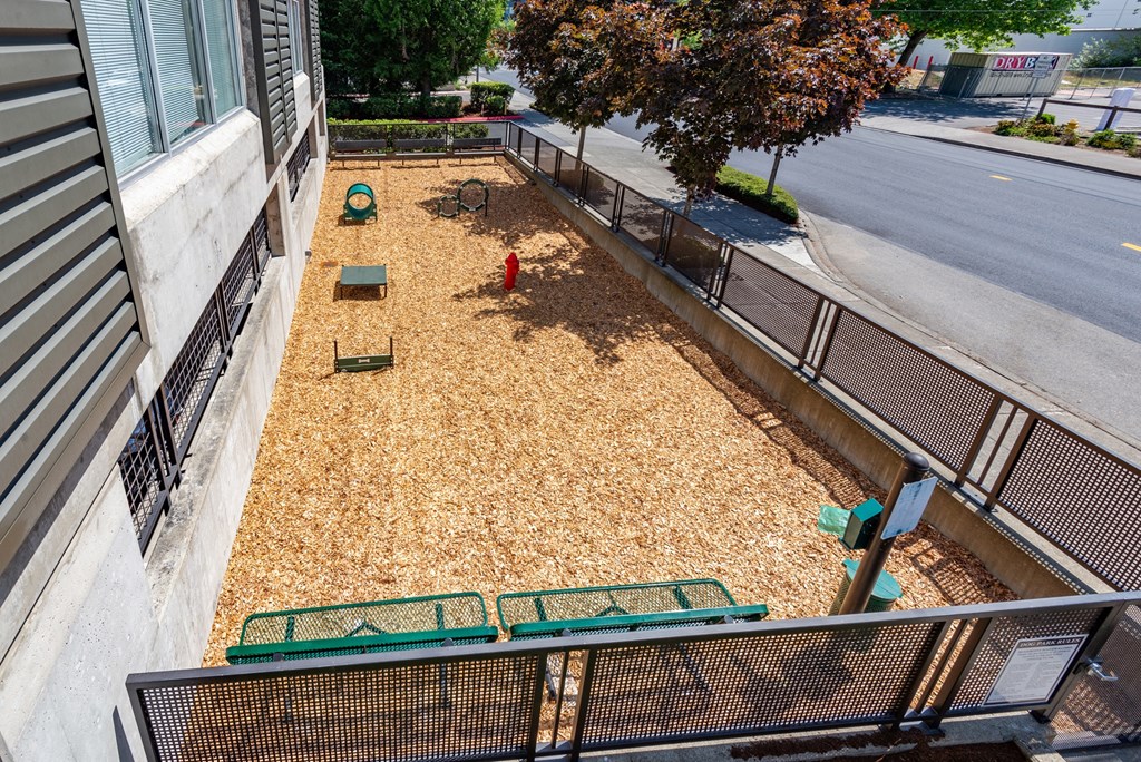 a view of a fire hydrant and benches on a sidewalk