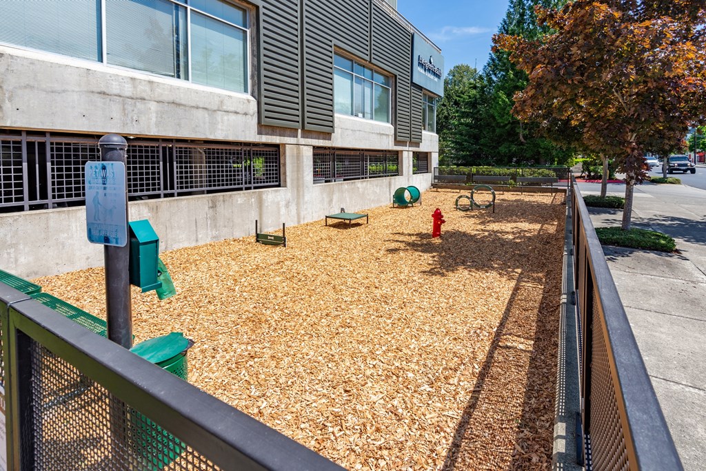a playground in front of a building with a red fire hydrant