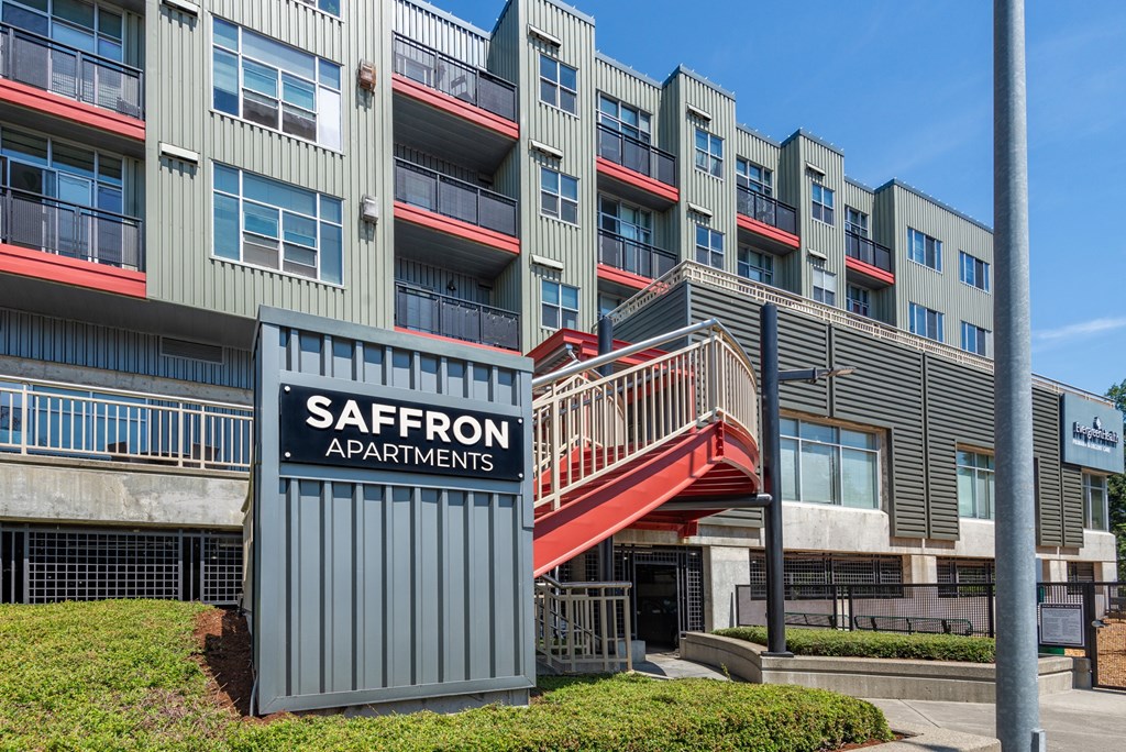 the exterior of a building with a staircase and a sign apartments