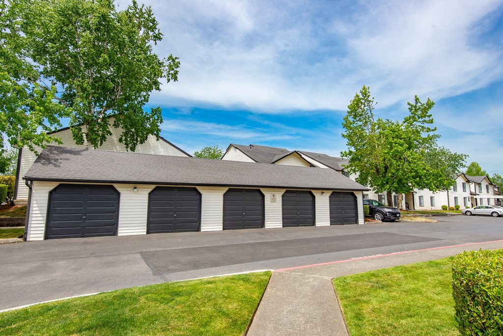 a house with two garages on the side of the road
