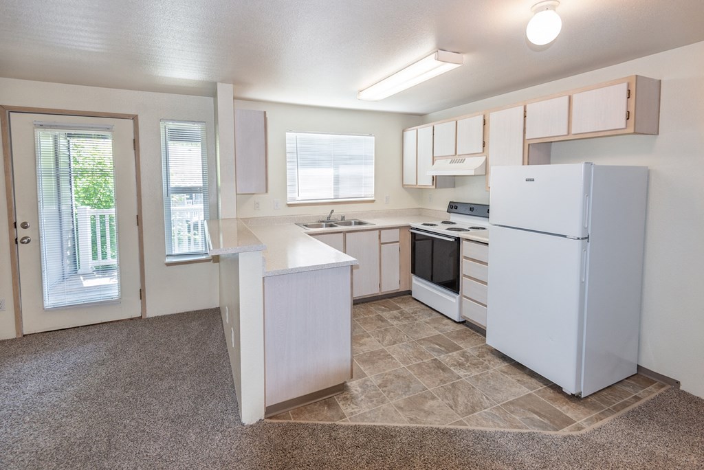 a kitchen with white cabinets and white appliances