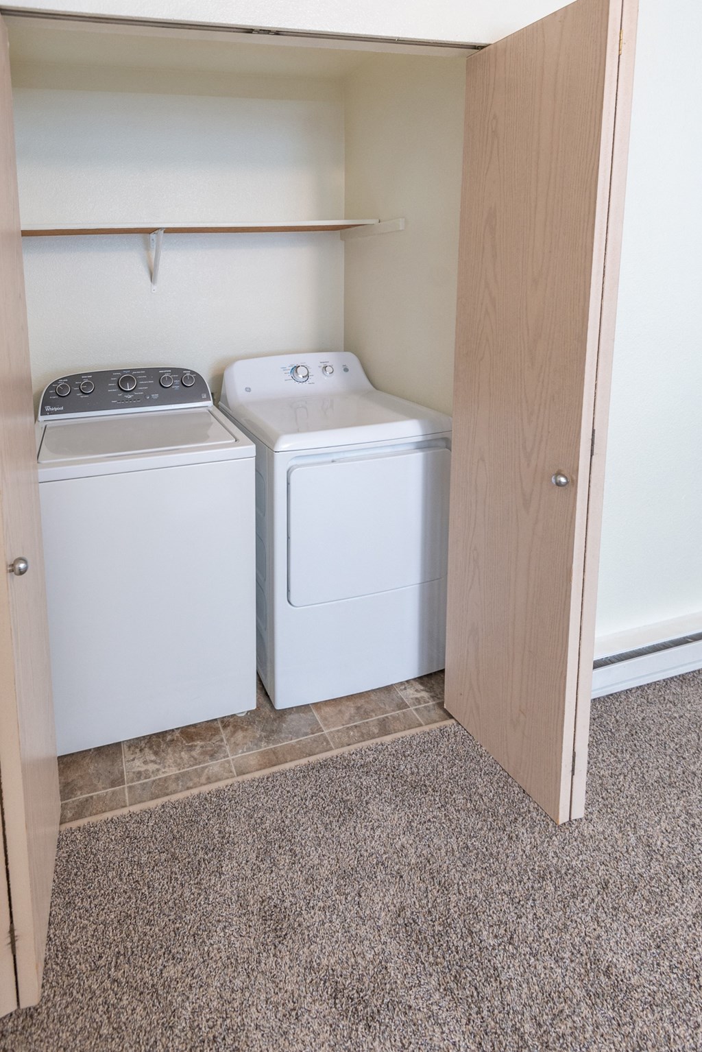 a small laundry room with a washer and dryer