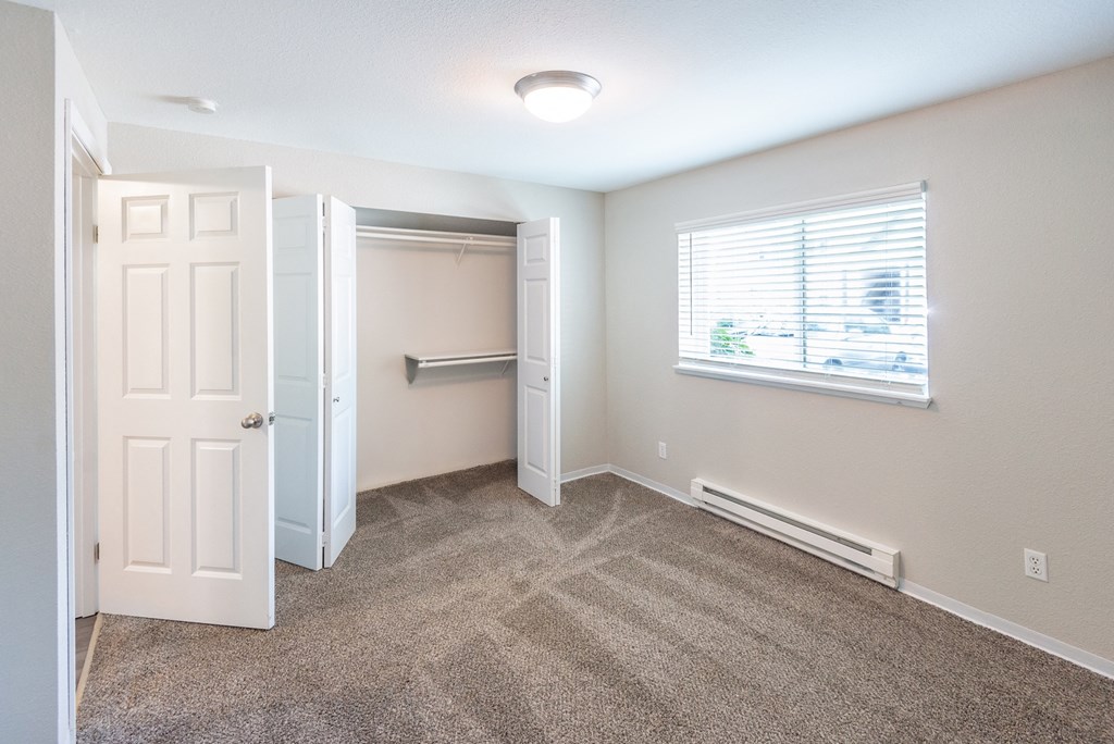 a bedroom with a closet and a window
