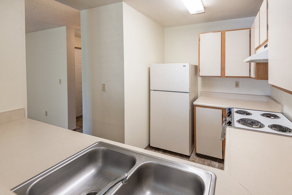 a kitchen with white appliances and white cabinets