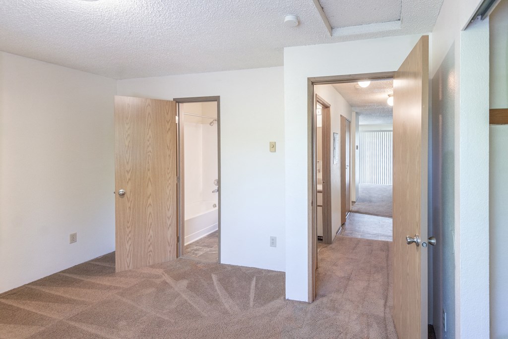 a view of a bedroom and hallway from the living room