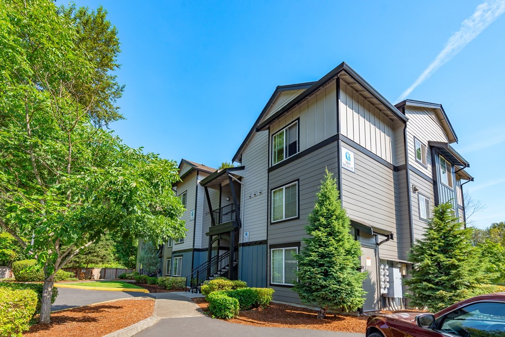 an apartment building with a car parked in front of it