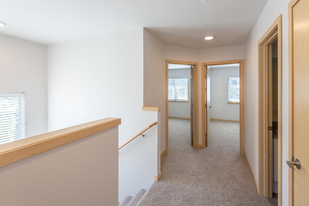 a view of the hallway from the top of the stairs in a 555 waverly unit
