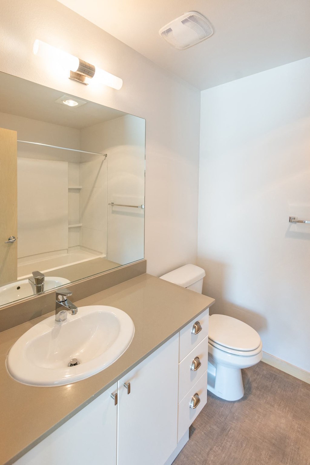 a bathroom with a sink toilet and mirror