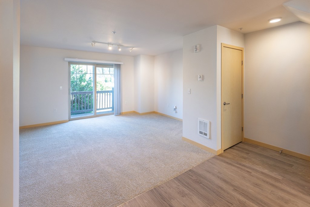 a bedroom with a door leading to a balcony
