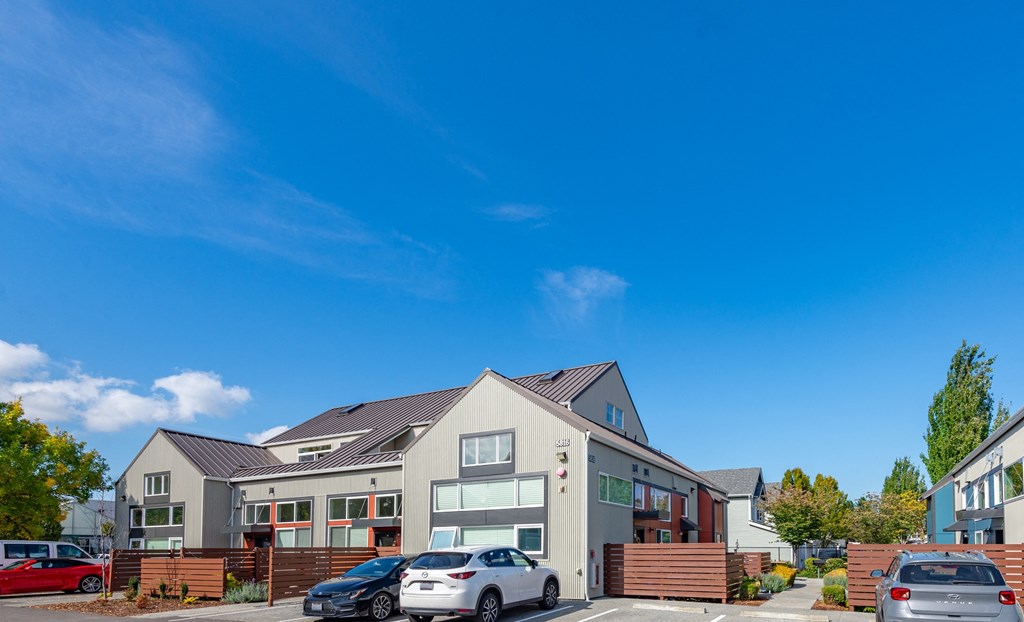 the exterior of a house with cars parked in front of it