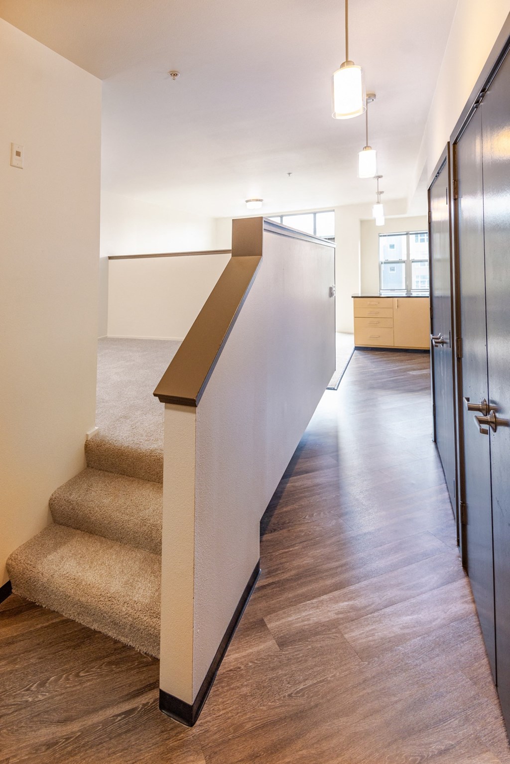 a hallway with stairs and a partition wall in a building