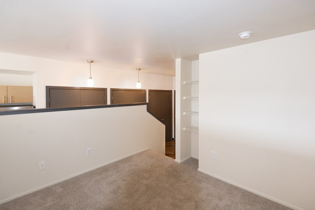 a living room with a carpeted floor and a white wall