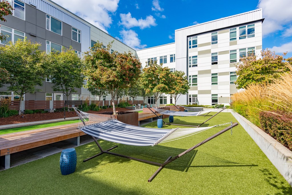 A modern building with a green lawn in front.