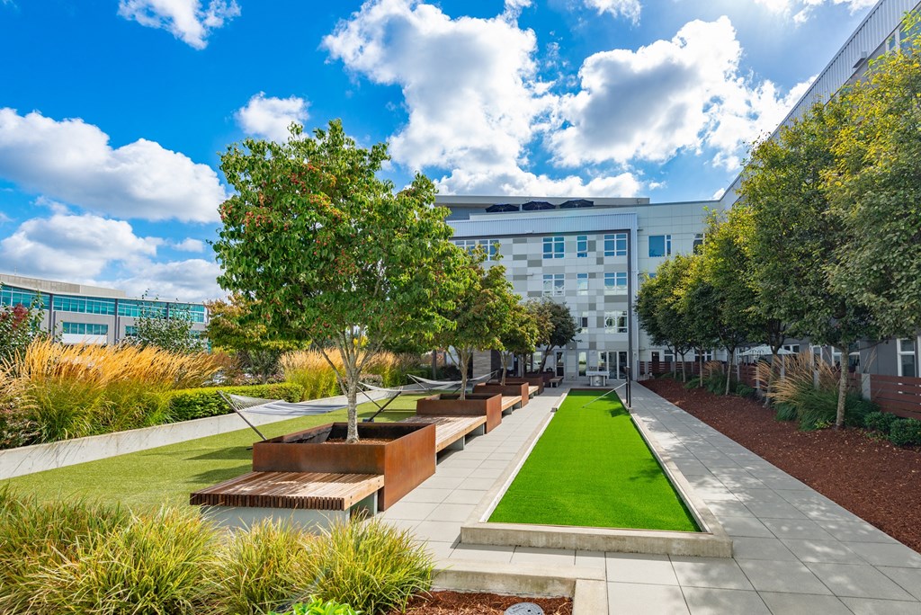 A modern building with a green lawn in front.