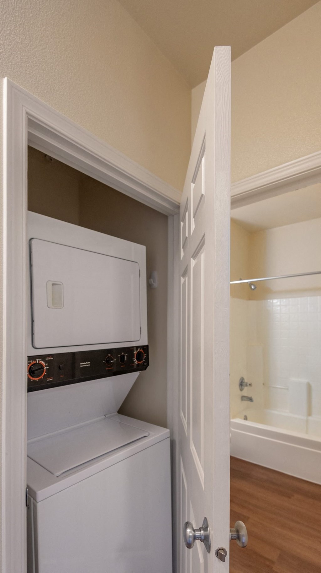 A white oven and dishwasher are built into a cabinet in a kitchen.