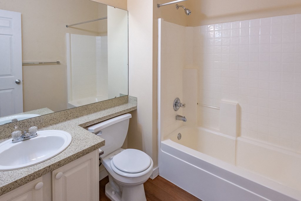 A white toilet sits next to a sink in a bathroom.