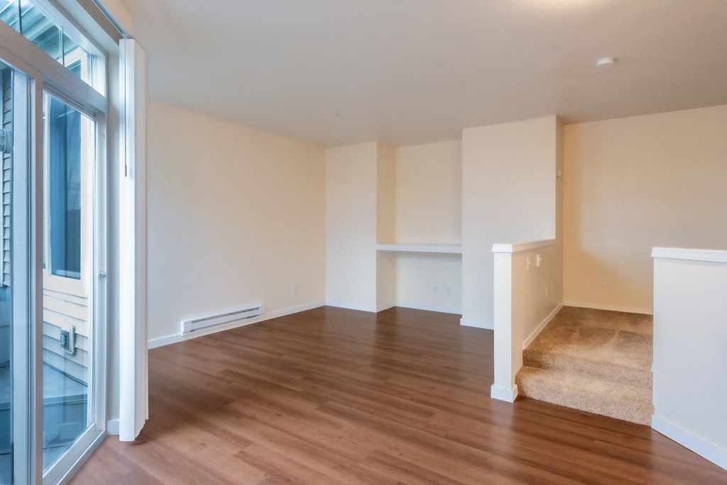 A room with wooden floors and white walls.