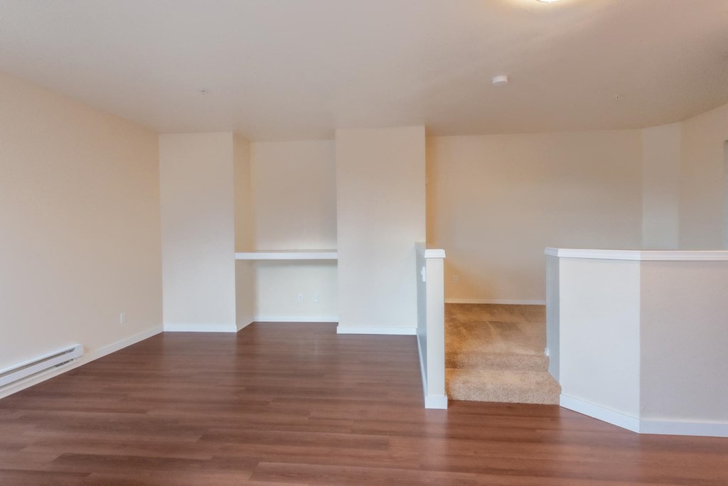 A room with wooden floors and white walls.