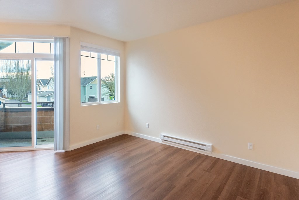 A room with a sliding glass door and a window.
