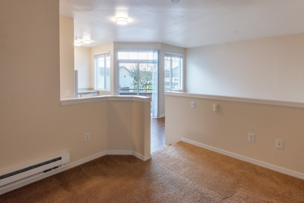 A room with a window and a door leading to another room.