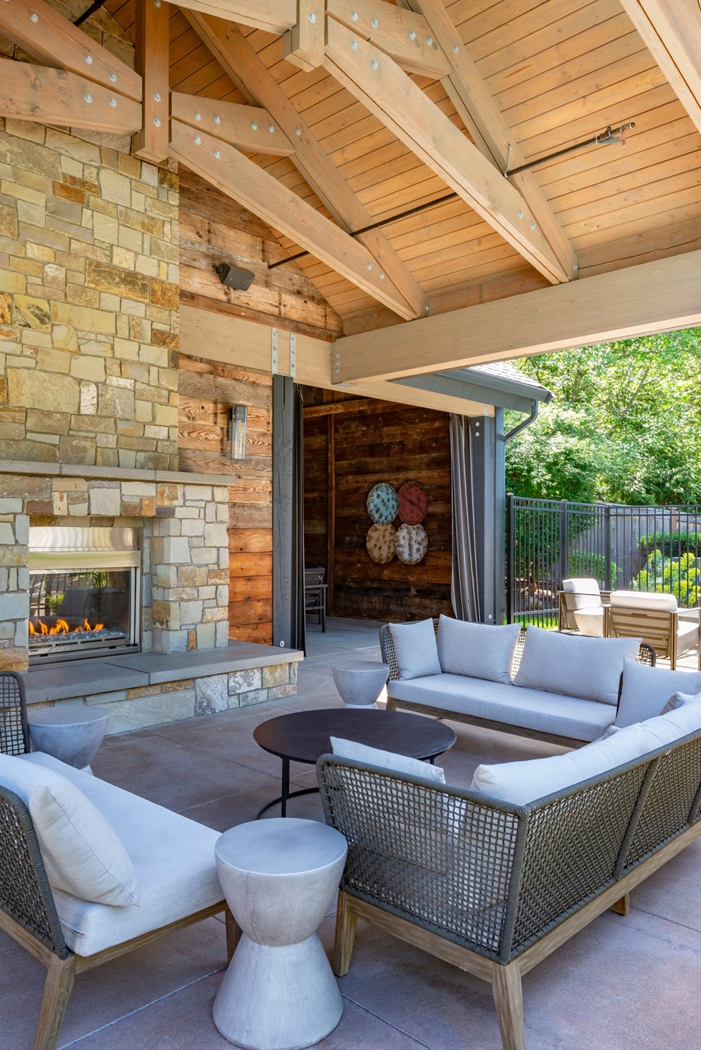 A patio with a fireplace and furniture.