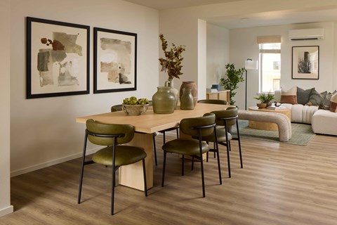A dining room with a table and chairs.