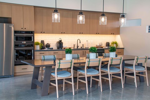 a large kitchen with a dining table and chairs