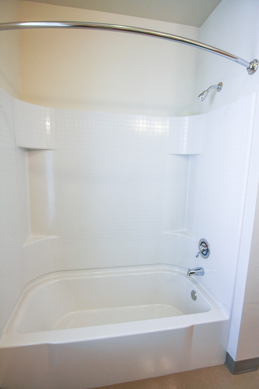 a white bathroom with a tub and a shower curtain