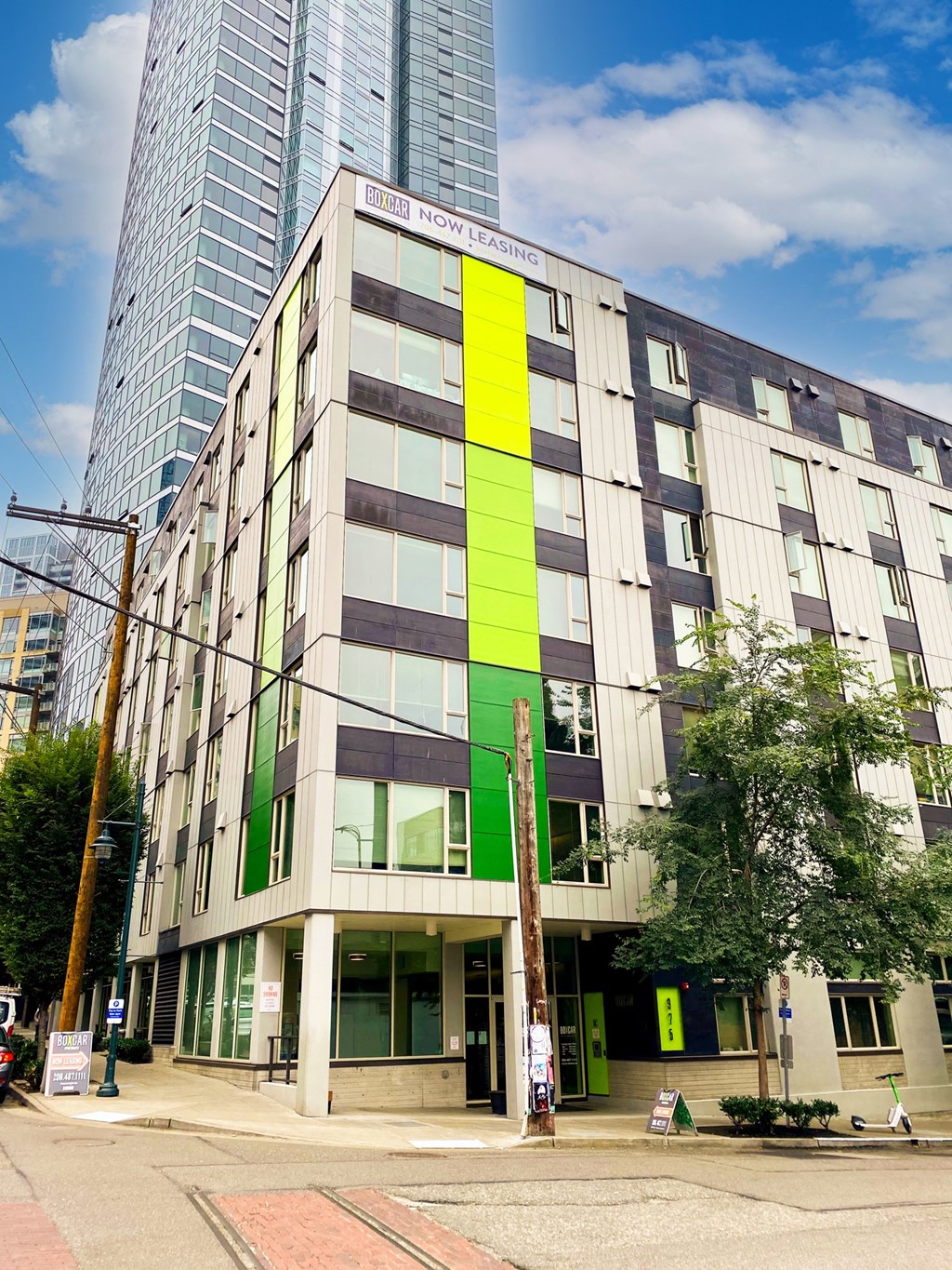 a large building with a green and yellow facade on a city street