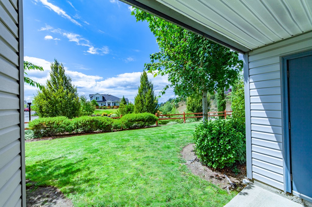 the backyard of a house with a yard and a fence
