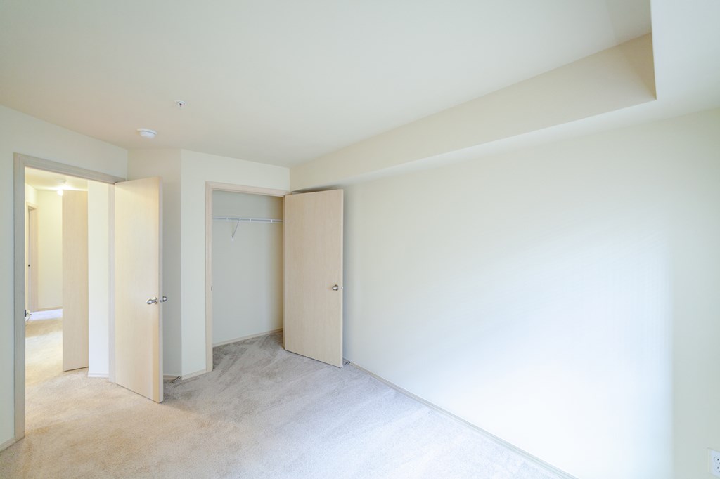 an empty room with white walls and doors