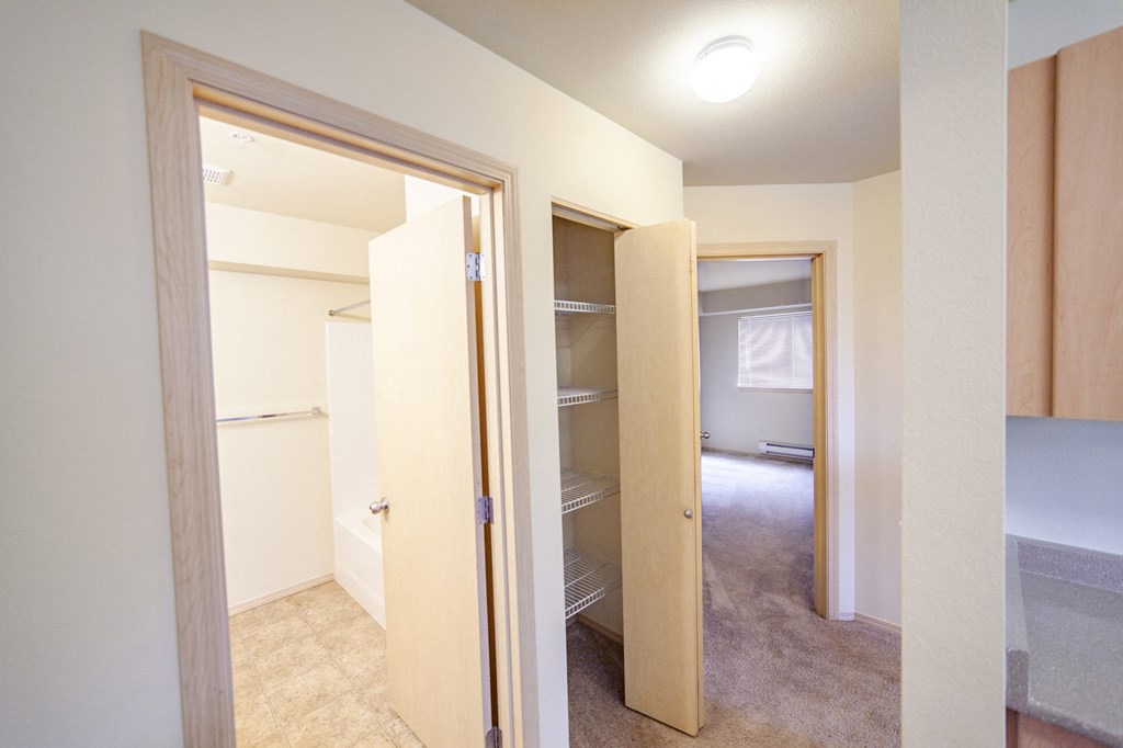 a bedroom with a closet and a mirror in a house