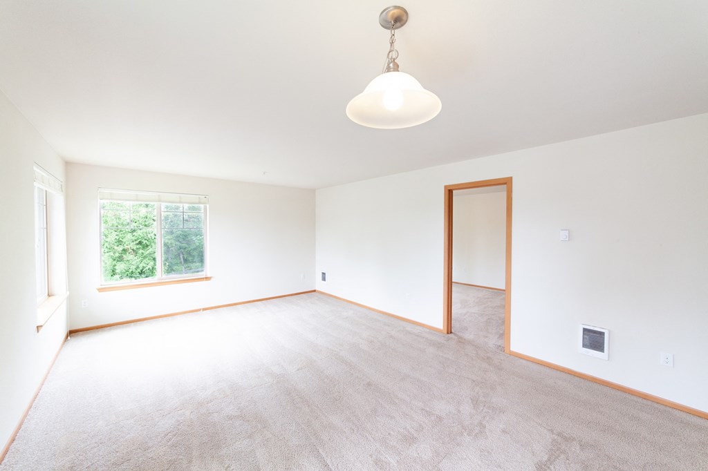 a bedroom with white walls and carpet