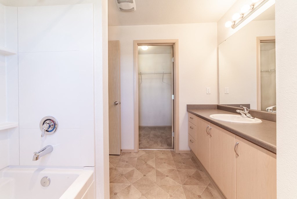 a bathroom with a bathtub and a sink