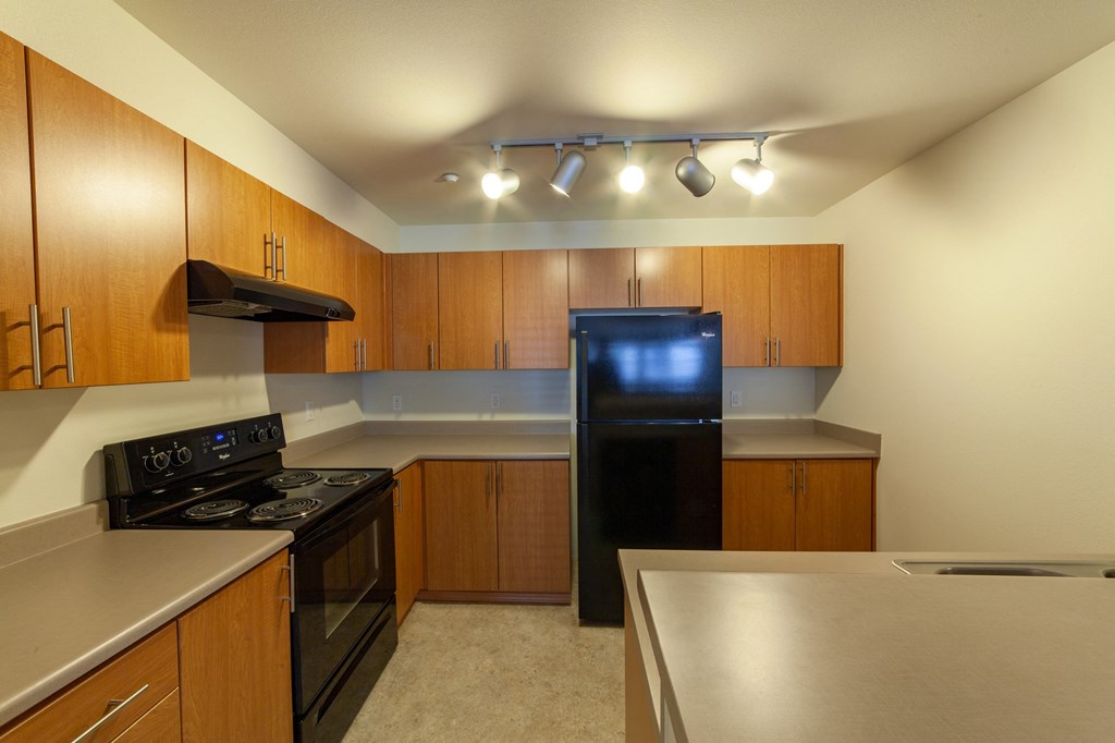 a kitchen with stainless steel counter tops and black appliances