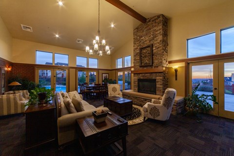a large living room with a fireplace and a table