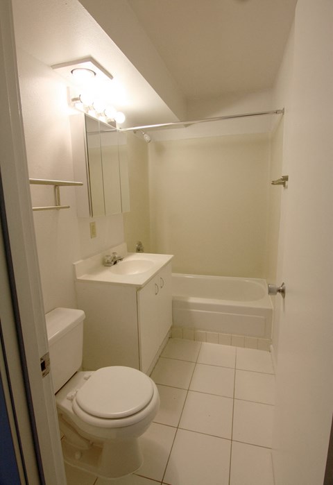 a bathroom with a toilet and a sink and a bath tub