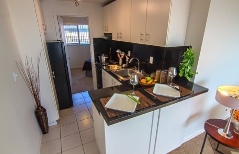 a kitchen or kitchenette with a counter and a sink