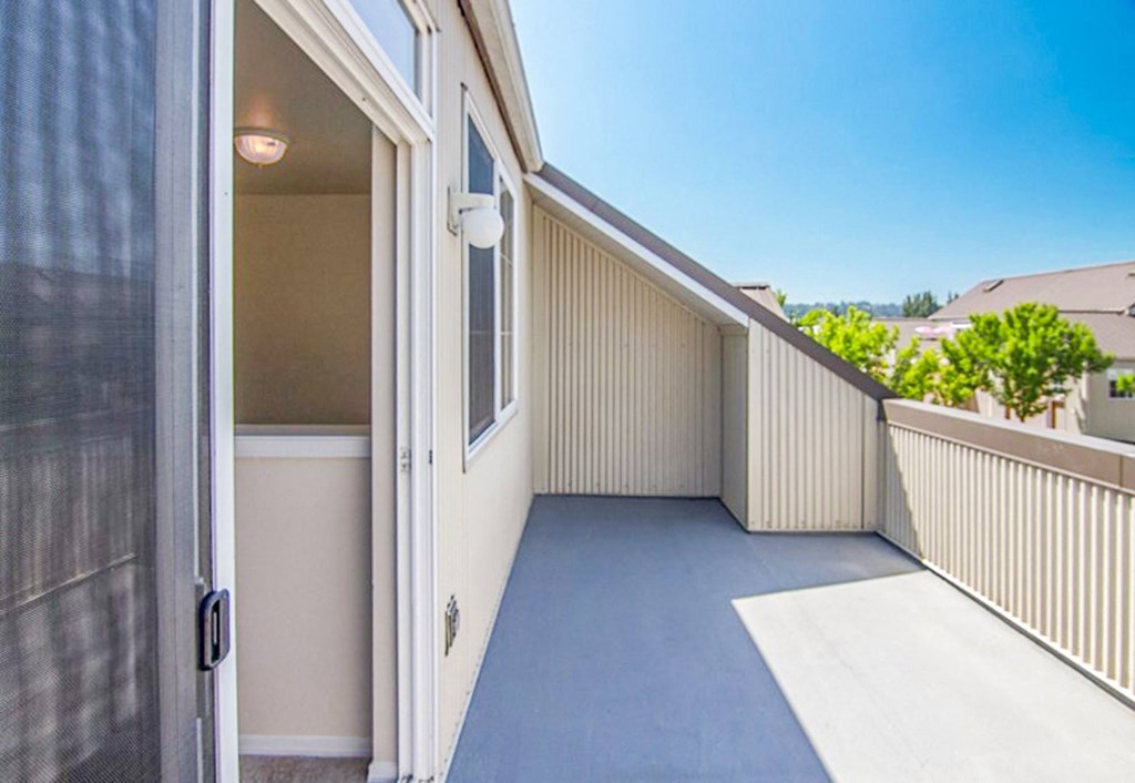 a patio with a door and a house next to it