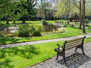park bench in front of a calming pond