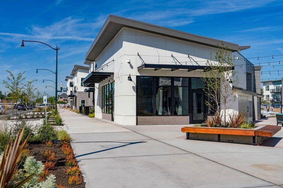 a city building with a sidewalk in front of it