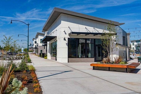 a city building with a sidewalk in front of it
