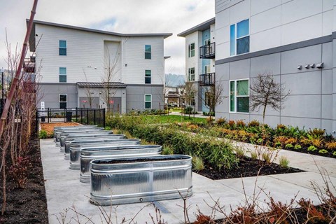 a row of metal benches in front of some buildings
