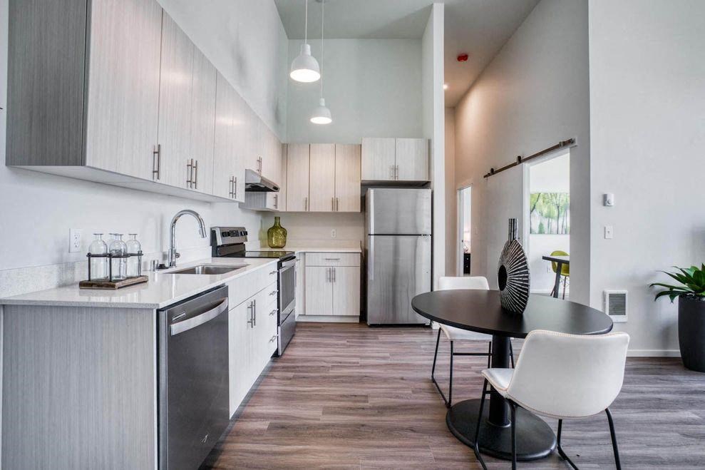 a kitchen and dining room with a table and chairs