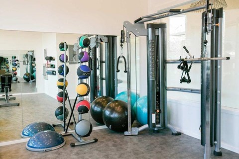 a workout room with weights and other gym equipment