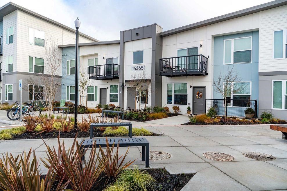 a courtyard in front of a building with a bench