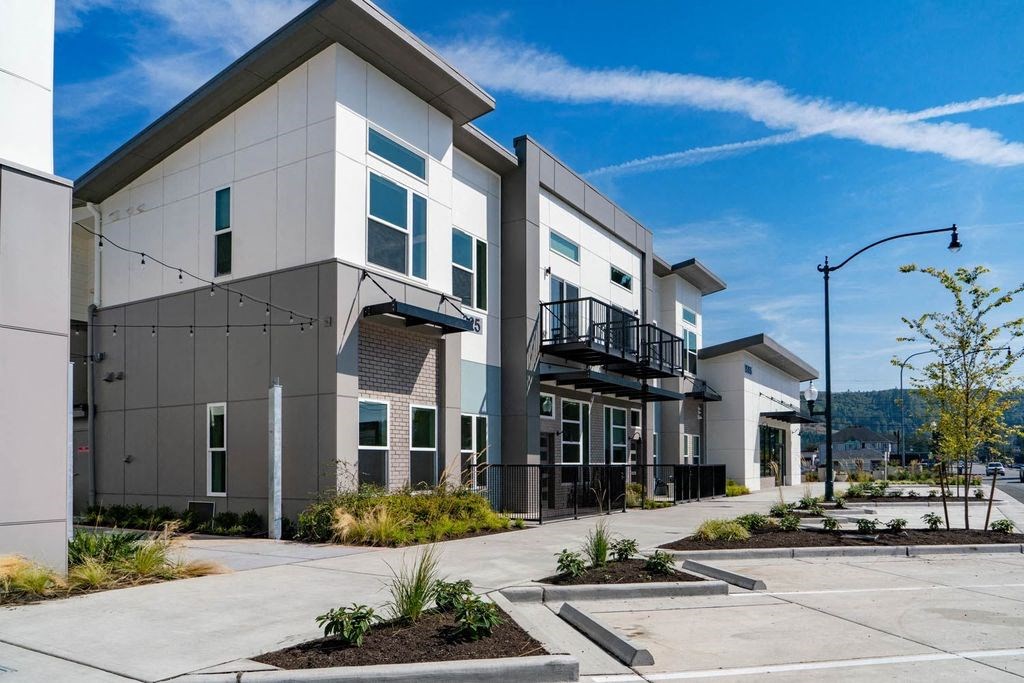 a new building with a sidewalk in front of it