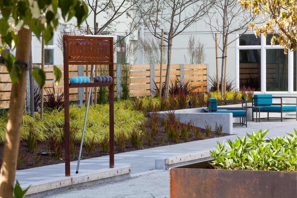 a park with benches and a sign in front of a building