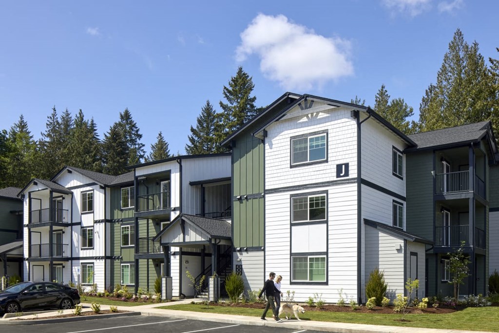 a person walking a dog in front of a building