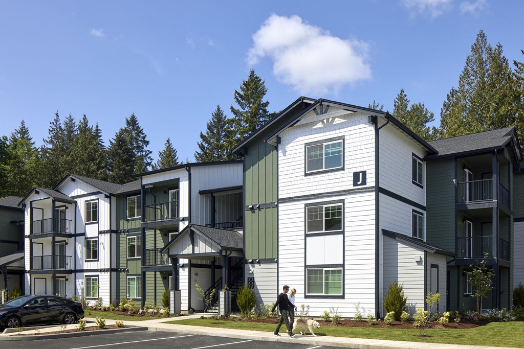 a person walking a dog in front of a building